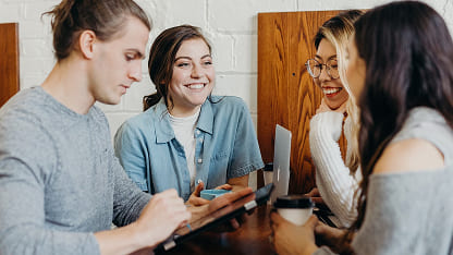 Group of students sitting talking at a table
